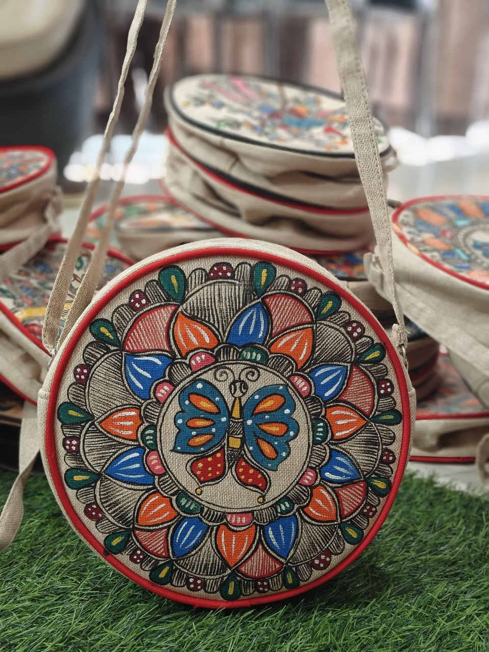 Round Madhubani sling bag with butterfly motif